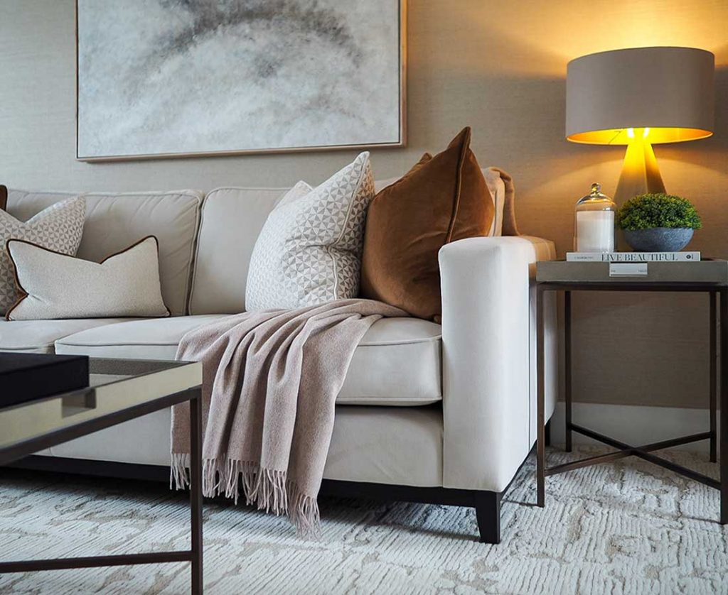 Luxury country house living room interior design in Berkshire featuring neutral sofa styling, textured cushions and layered lighting