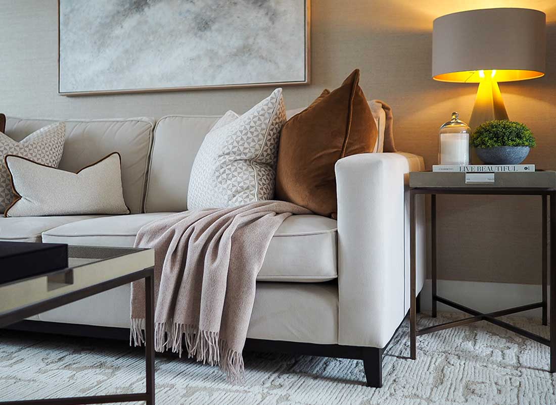 Luxury country house living room interior design in Berkshire featuring neutral sofa styling, textured cushions and layered lighting