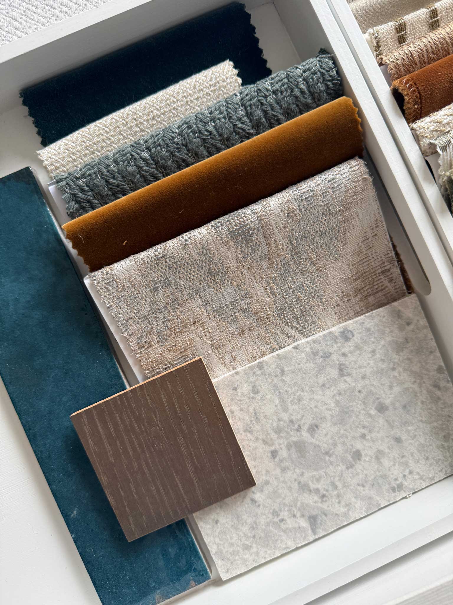 Interior materials palette combining textiles, timber and stone
