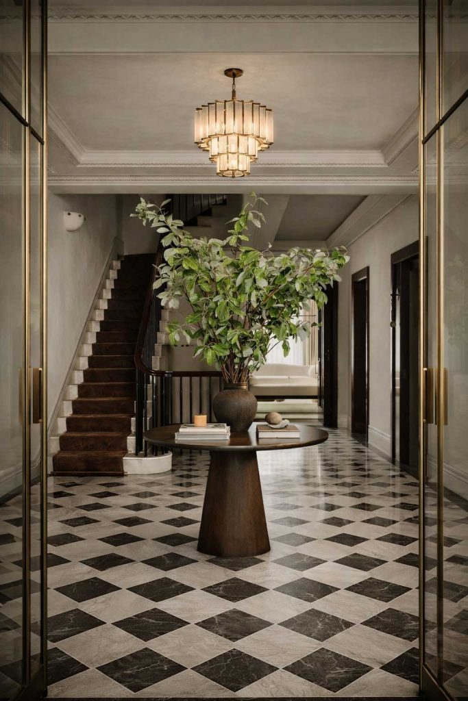 Luxury entryway checkerboard marble floor curved staircase cgi